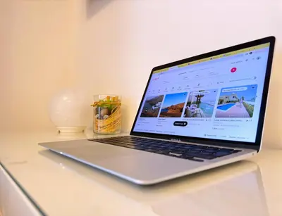 a laptop computer sitting on top of a desk at WOW Studio w/ Balcony and Canal View in Marina in Dubai