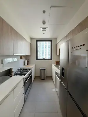 a kitchen with white cabinets and stainless steel appliances at 3 bedrooms + maids room, Full Park view in Dubai