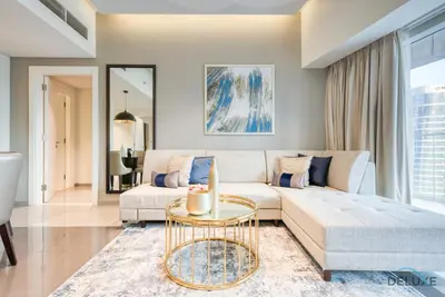 a living room with a couch and a table at Overlooking Canal Views, Fam-Friendly 2BR Unit, Damac Majestine Tower, Business Bay by Deluxe Holiday Homes in Dubai