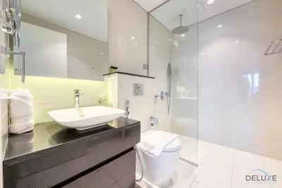 a bathroom with a sink and a shower at Overlooking Canal Views, Fam-Friendly 2BR Unit, Damac Majestine Tower, Business Bay by Deluxe Holiday Homes in Dubai