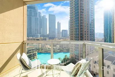 a balcony with a view of a city skyline at LUX The Stunning Fountain View Suite in Dubai