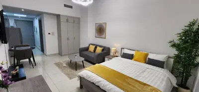 a bedroom with a bed and a living room at Elite 6 Residence - Sports City by Golden Casa in Dubai