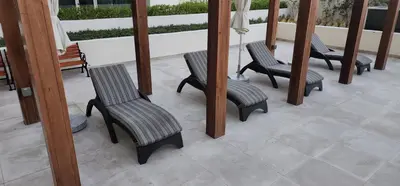 a group of chairs sitting on a patio at Shaista Azizi Residence - Al Furjan by Golden Casa in Dubai