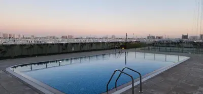 a large swimming pool on top of a building at Shaista Azizi Residence - Al Furjan by Golden Casa in Dubai