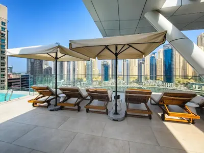 a group of chairs and umbrellas on a roof at Breathtaking views from Vida Dubai Marina in Dubai