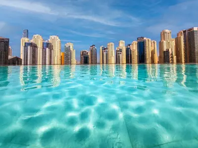 a city viewed from the water in front of a city at Breathtaking views from Vida Dubai Marina in Dubai