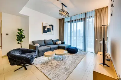a living room with a couch and a table at Panoramic canal views from brand new 3BD apartment in Dubai
