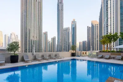 a large swimming pool in a city with tall buildings at GuestReady - Glamourous home in Downtown Dubai in Dubai