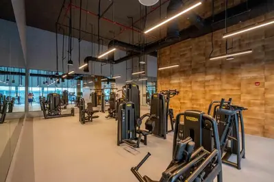 a gym with several rows of treadmills and ellipticals at GuestReady - Glamourous home in Downtown Dubai in Dubai