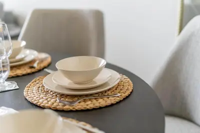 a table with plates and a cup and a bowl at GuestReady - Glamourous home in Downtown Dubai in Dubai