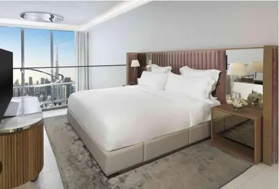 a bedroom with a large white bed and a large window at Best View Security System Burj Kalifa View in Dubai