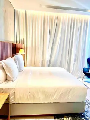 a bedroom with a white bed and a window at Best View Security System Burj Kalifa View in Dubai