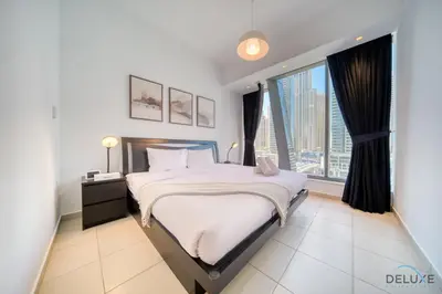 a bedroom with a bed and a large window at Beautiful 2BR at Silverene Towers A Dubai Marina by Deluxe Holiday Homes in Dubai
