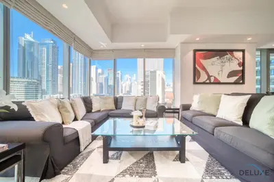 a living room with a couch and a table at Beautiful 2BR at Silverene Towers A Dubai Marina by Deluxe Holiday Homes in Dubai