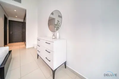 a white dresser with a mirror on top of it at Beautiful 2BR at Silverene Towers A Dubai Marina by Deluxe Holiday Homes in Dubai
