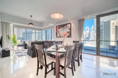 a dining room with a table and chairs at Beautiful 2BR at Silverene Towers A Dubai Marina by Deluxe Holiday Homes in Dubai