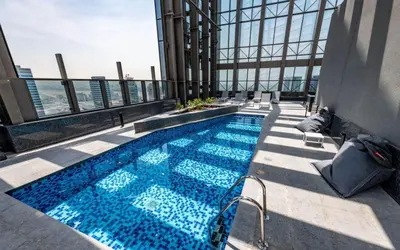 a swimming pool on top of a building at Luxurious & Modern 2BR Plus Maid, Sparkle Tower Dubai Marina - 10AB4 in Dubai