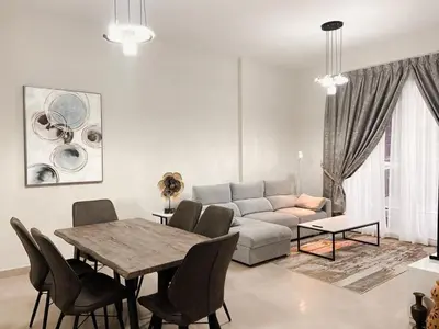 a living room with a table and a couch at Luxurious & Modern 2BR Plus Maid, Sparkle Tower Dubai Marina - 10AB4 in Dubai