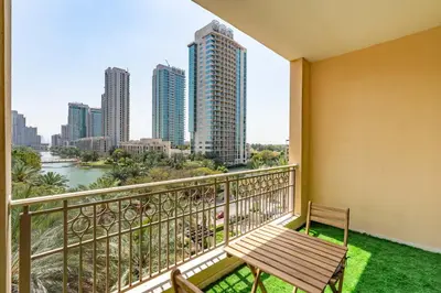 a balcony with a bench and a view of the city at Lux BnB I Una Tower I Lakes View in Dubai