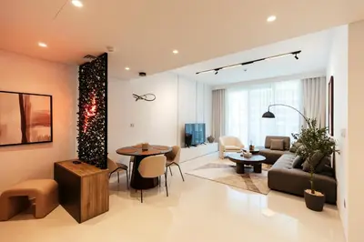 a living room with a couch and a table at Luxurious Waterfront 1BR with Stunning Sea Views - 15AB02 in Dubai