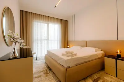 a bedroom with a large bed and a mirror at Luxurious Waterfront 1BR with Stunning Sea Views - 15AB02 in Dubai