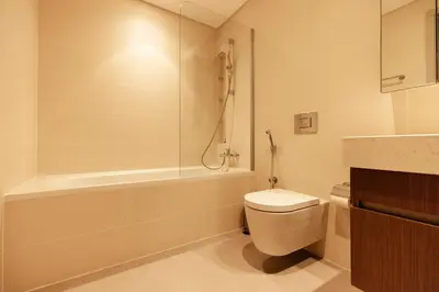 a bathroom with a toilet and a bath tub at Luxurious Waterfront 1BR with Stunning Sea Views - 15AB02 in Dubai