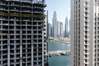 a view of a city from between two tall buildings at Luxurious Waterfront 1BR with Stunning Sea Views - 15AB02 in Dubai