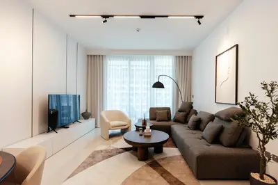 a living room with a couch and a tv at Luxurious Waterfront 1BR with Stunning Sea Views - 15AB02 in Dubai