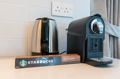 a phone sitting on top of a counter next to a toaster at Mystic - Forte Tower 2 in Dubai