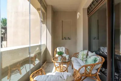 a balcony with chairs and a table on a balcony at Mystic - Fully Renovated Spacious 2BR Apt. with Burj Views in Dubai