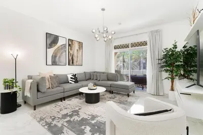 a living room with a couch and a table at Mystic - Fully Renovated Spacious 2BR Apt. with Burj Views in Dubai