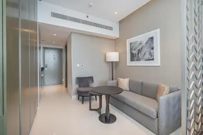 a living room with a couch and a table at Mystic - Damac Maison Prive Tower B in Dubai