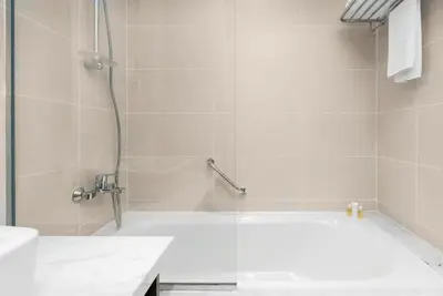 a bathroom with a tub and a sink and a shower at Mystic - Damac Maison Prive Tower B in Dubai