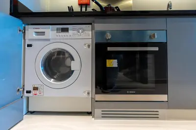 a washing machine next to a dishwasher in a kitchen at Mystic - Damac Maison Prive Tower A in Dubai