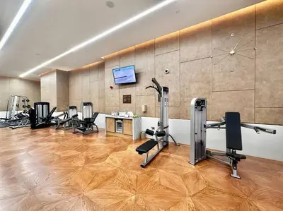a room with a gym with chairs and a tv at Luxury Studio in High Floor Full Sea View in The Palm Tower Plam Jumeirah in Dubai