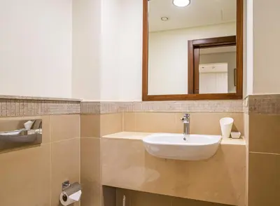 a bathroom with a sink and a mirror at Vacay Lettings - Stunning Burj Khalifa fountain view near Dubai mall in Dubai