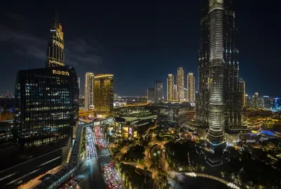 a city skyline at night with many tall buildings at Vacay Lettings - Stunning Burj Khalifa fountain view near Dubai mall in Dubai