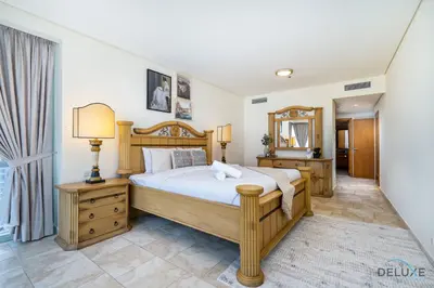 a bedroom with a large bed and a mirror at Sophisticated 3BR w/ Assistant’s Room at Al Fattan Marine Towers 2 JBR by Deluxe Holiday Homes in Dubai