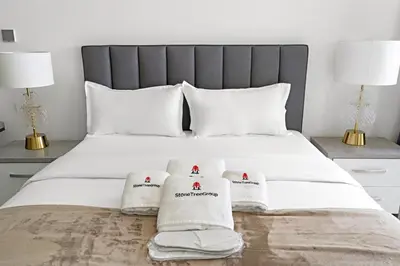 a bedroom with a bed with towels on it at StoneTree - Modern Studio - Special Offer! in Dubai