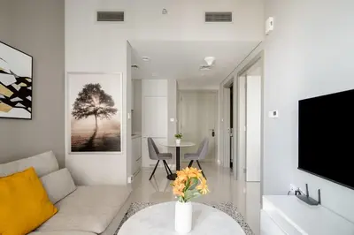 a living room with a couch and a tv at Pool View One Bed Room Business Bay in Dubai