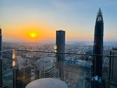 a view of a city at sunset from a skyscraper at The Address Residences Dubai Opera in Dubai