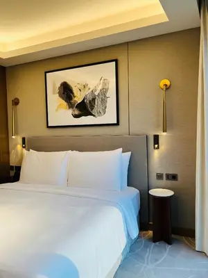 a bedroom with a white bed and a picture on the wall at The Address Residences Dubai Opera in Dubai