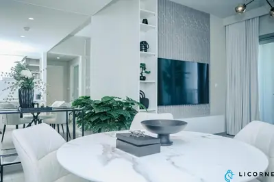 a living room with a table and white chairs at Unveil Downtown Luxury, 1BR Majestic Skyline Views - Downtown Views ll in Dubai