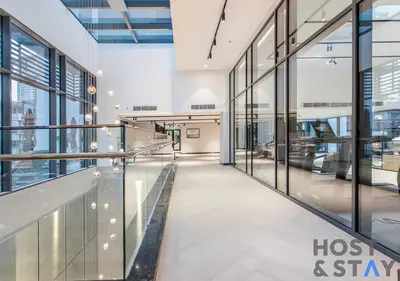 a hallway in a building with glass windows at Luxury Studio at Wilton Park - MBR in Dubai