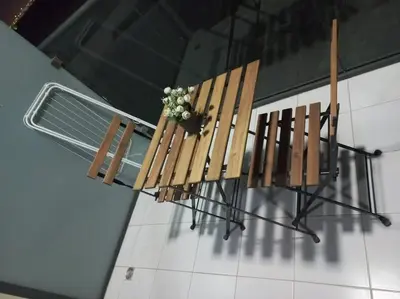two wooden chairs and a table with a plant on it at StoneTree - Furnished Studio - Celestia B in Dubai