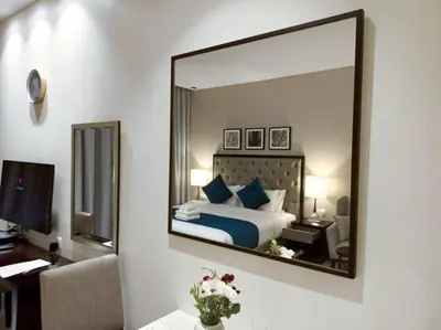 a bedroom with a bed with a large mirror at StoneTree - Furnished Studio - Celestia B in Dubai