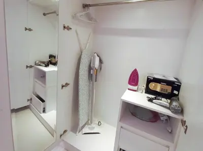a small white room with a sewing machine on a shelf at StoneTree - Furnished Studio - Celestia B in Dubai