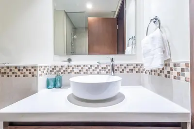 a bathroom with a large white bowl sink on a counter at TruStay Vacation Home Rentals - Business Bay in Dubai