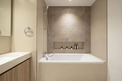 a bathroom with a bath tub and a sink at Downtown - Burj Khalifa Facing - 2 Bed Luxe Apartment in Dubai