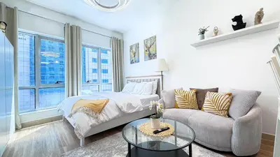a living room with a bed and a couch at Dubai Marina - Modern Designed - Gorgeous Studio- Close Metro Station in Dubai